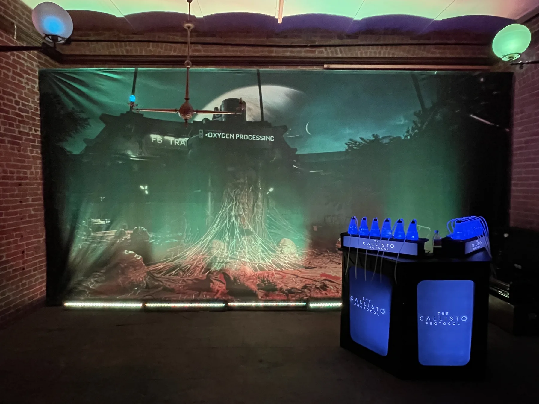 An oxygen bar in front of an illustrated event backdrop